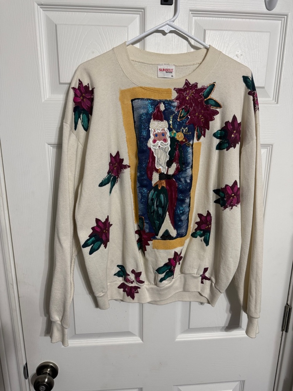 Sunbelt Cream Crewneck Sweater with Santa & Purple Floral Appliqués